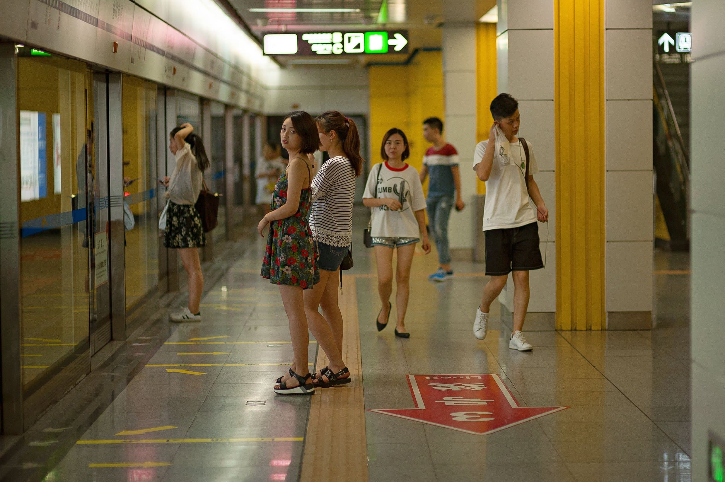 Commuters waiting on a metro station platform in Guangzhou